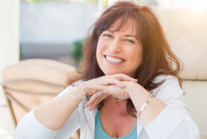 a patient smiling after her gum disease treatment