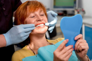 Dental Patient Smiling During Her Full Arch Dental Implant Procedure