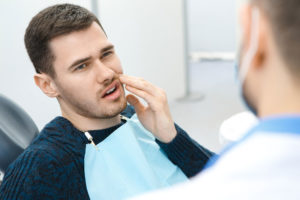 Dental Patient Suffering From Mouth Pain On A Dental Chair, In San Antonio, TX