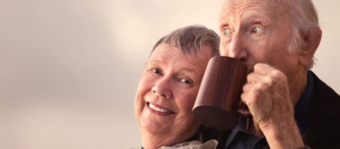Two Dental Implant Patients Smiling Together While Drinking Coffee