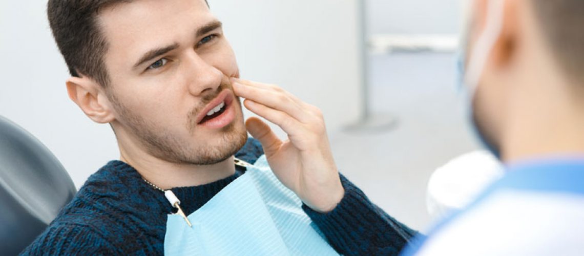 Dental Patient Suffering From Mouth Pain On A Dental Chair, In San Antonio, TX