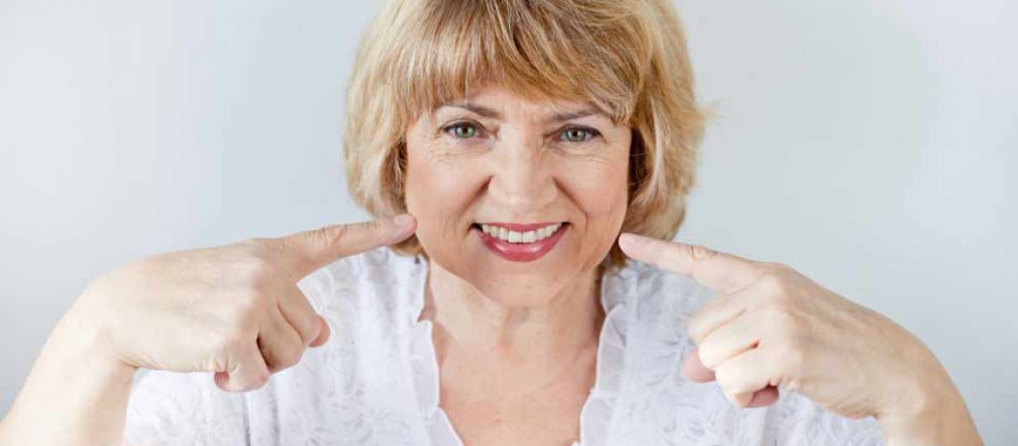 patient smiling with her new dental implant